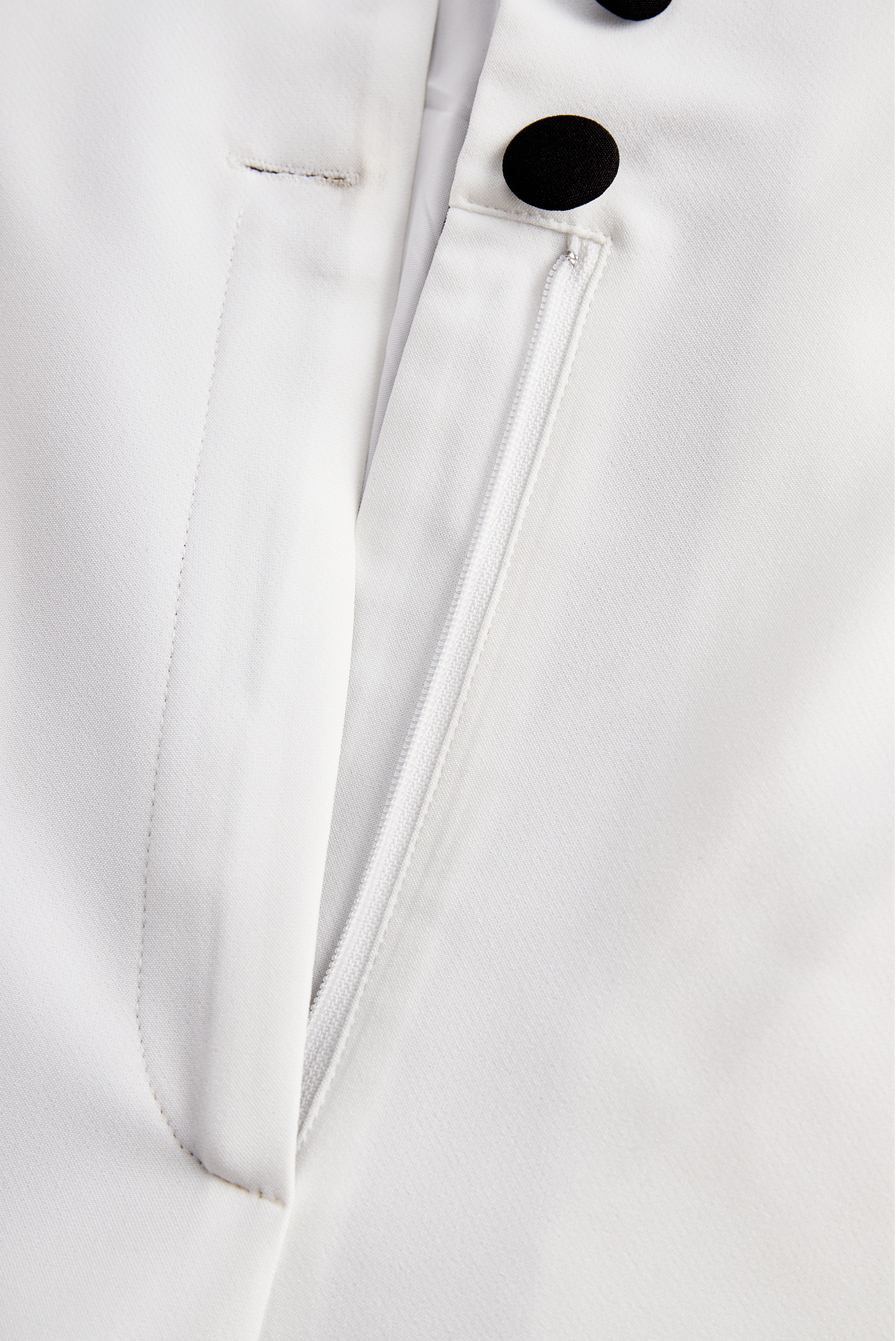 Sleek White Jumpsuit With Dual Button Detail And Black Lapel | Elegant Women's Dress